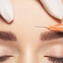 Botox being injected into the forehead.